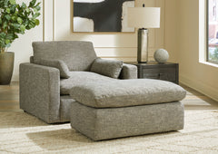 On the days when rest and relaxation seem out of reach, this oversized chair and ottoman provides a positively plush seating experience. Its feather-fiber blend cushions invite you to float away in cloud-like comfort. Striking granite-hued upholstery and 
