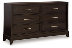 This dresser combines modern and art deco styles for both traditional and contemporary arrangements. With elegant stepped moulded framing and ample storage, it adds dimension to your sanctuary while keeping your belongings organized and clutter-free. Indu