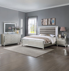 Elevate your sanctuary with this dazzling bedroom collection, where contemporary chic meets timeless charm. The suite boasts a stunning silver finish, imbuing your space with an air of sophistication and modern luxury. At the heart lies a plush, channel t