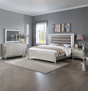 Elevate your sanctuary with this dazzling bedroom collection, where contemporary chic meets timeless charm. The suite boasts a stunning silver finish, imbuing your space with an air of sophistication and modern luxury. At the heart lies a plush, channel t