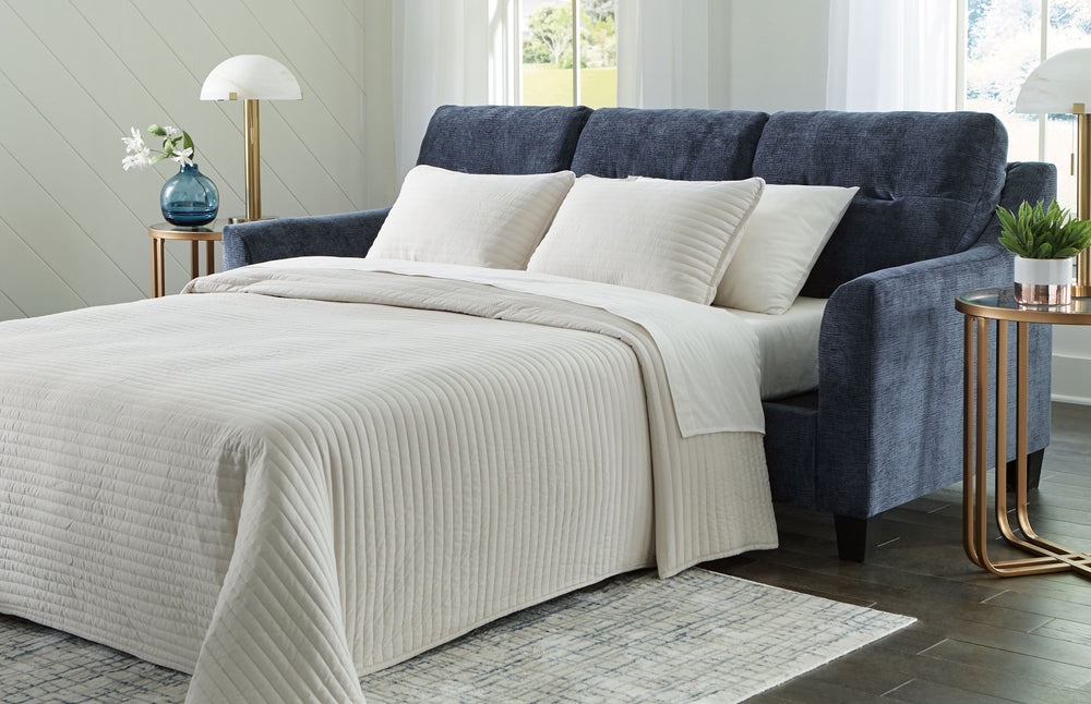 Urban contemporary meets mid century (with a pop of trend-right color) in this queen sofa chaise sleeper. Supremely soft upholstery, teeming with luster and movement, finesses the piece with just the right touch. Gently flared arms and tufted back cushion