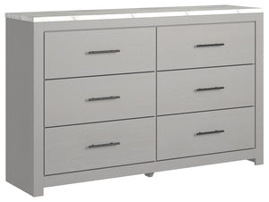 Cool, clean and casually modern. This dresserâ€™s wispy dove gray finish and faux Calcutta marble top set the tone for your calming sanctuary. Large linear pulls add dimension and authenticity. Six smooth-gliding drawers neatly accommodate your wardrobe n