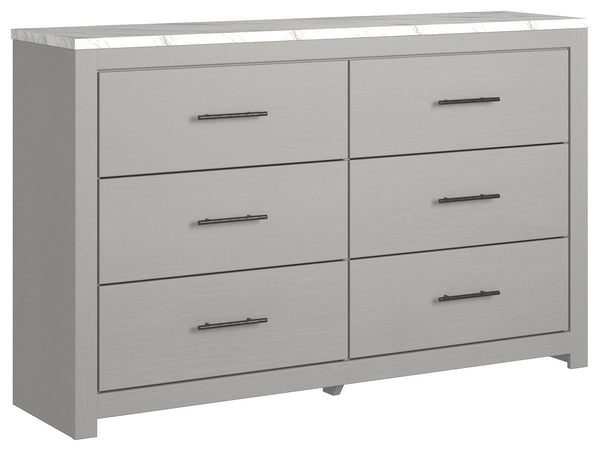 Cool, clean and casually modern. This dresserâ€™s wispy dove gray finish and faux Calcutta marble top set the tone for your calming sanctuary. Large linear pulls add dimension and authenticity. Six smooth-gliding drawers neatly accommodate your wardrobe n