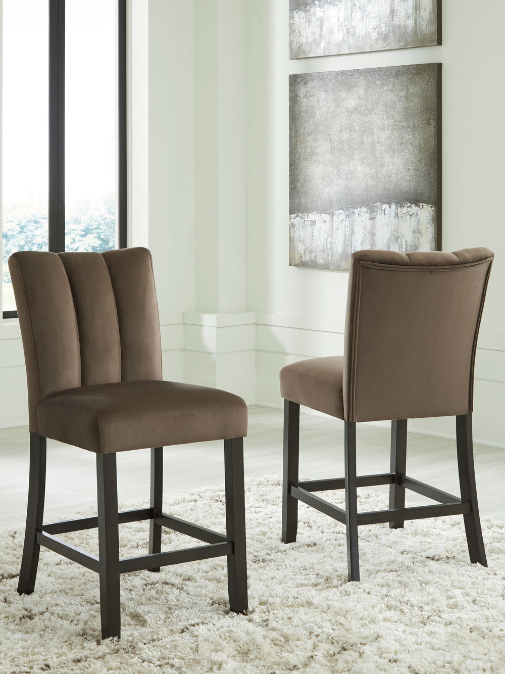 This counter height bar stool reflects your highly contemporary point of view. Its ultra-soft velvet upholstery in chocolate brown is a feast for the senses. Channel stitching details give the stool an elevated, tailored feel. What a delicious choice for 