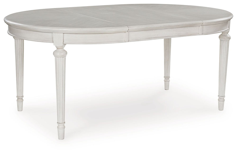 Transform your home into a haven of timeless elegance with this dining extension table. Traditionally styled, its classic antiqued white finish is paired with reeded legs and a tabletop with a butterfly-matched veneer pattern. With the removable center le