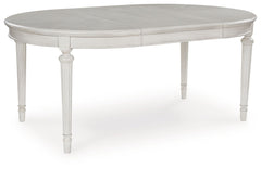 Transform your home into a haven of timeless elegance with this dining extension table. Traditionally styled, its classic antiqued white finish is paired with reeded legs and a tabletop with a butterfly-matched veneer pattern. With the removable center le