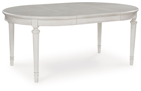 Transform your home into a haven of timeless elegance with this dining extension table. Traditionally styled, its classic antiqued white finish is paired with reeded legs and a tabletop with a butterfly-matched veneer pattern. With the removable center le