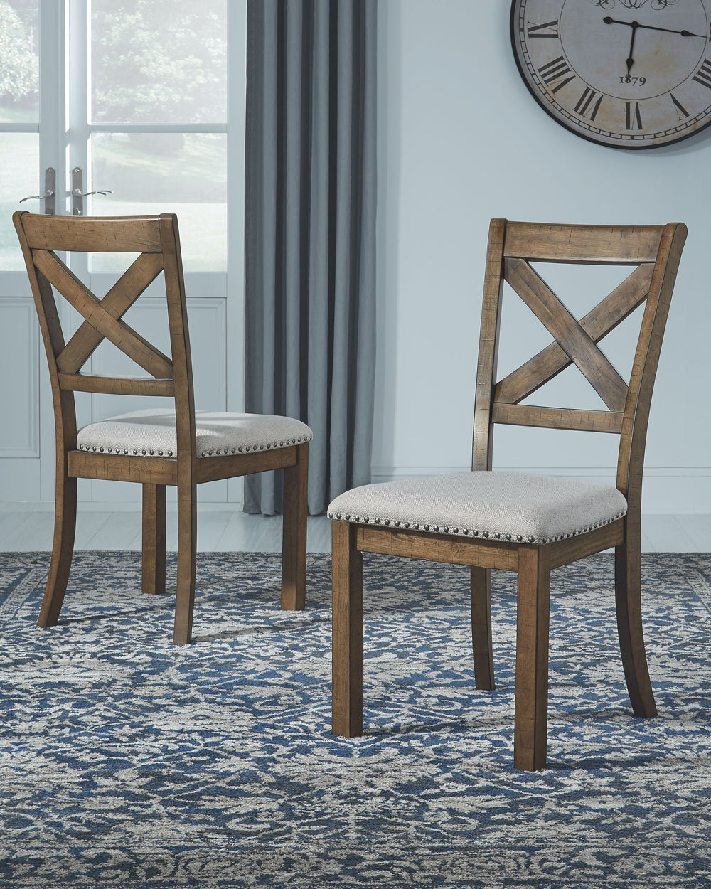 This upholstered dining chair elevates the art of casual rustic style. With a distressed nutmeg finish, antiqued nailhead trim and textured polyester fabric, this upholstered dining chair with classic X back styling entices with warmth and earthy elegance