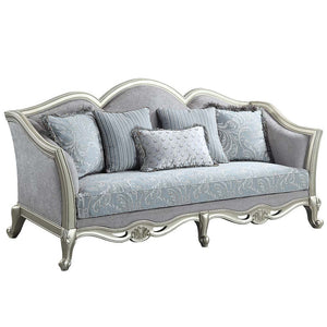 With a timeless silhouette influenced by French beauty, this Qunsia sofa makes a gracious statement in a comforting light gray linen upholstery fabric. Delicate curves invite the eye, while cabriole legs the champagne wooden trim that adds visual impact. 