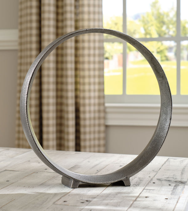  this sculpture rounds out your decor in sleek style. The antiqued pewter-tone finish has a chic appeal that remains versatile