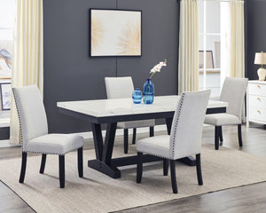 A fresh take on a traditional silhouette makes this group a great addition to your dining space. A faux marble top provides an elegant look while being easy to care for. The trestle base is updated in a contemporary charcoal finish. The upholstered dining