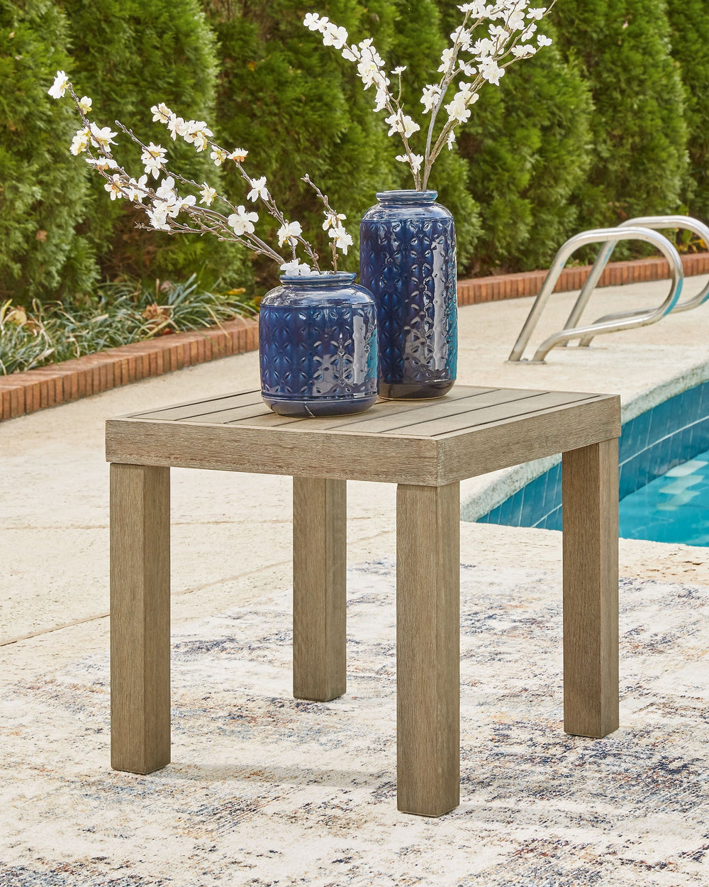 Beautifully on point, this outdoor end table is the natural choice for modern minimalists who know that less is more. Quality crafted of eucalyptus wood, this ultra clean-lined outdoor table is enriched with a multi-step embossed finish that both brings o