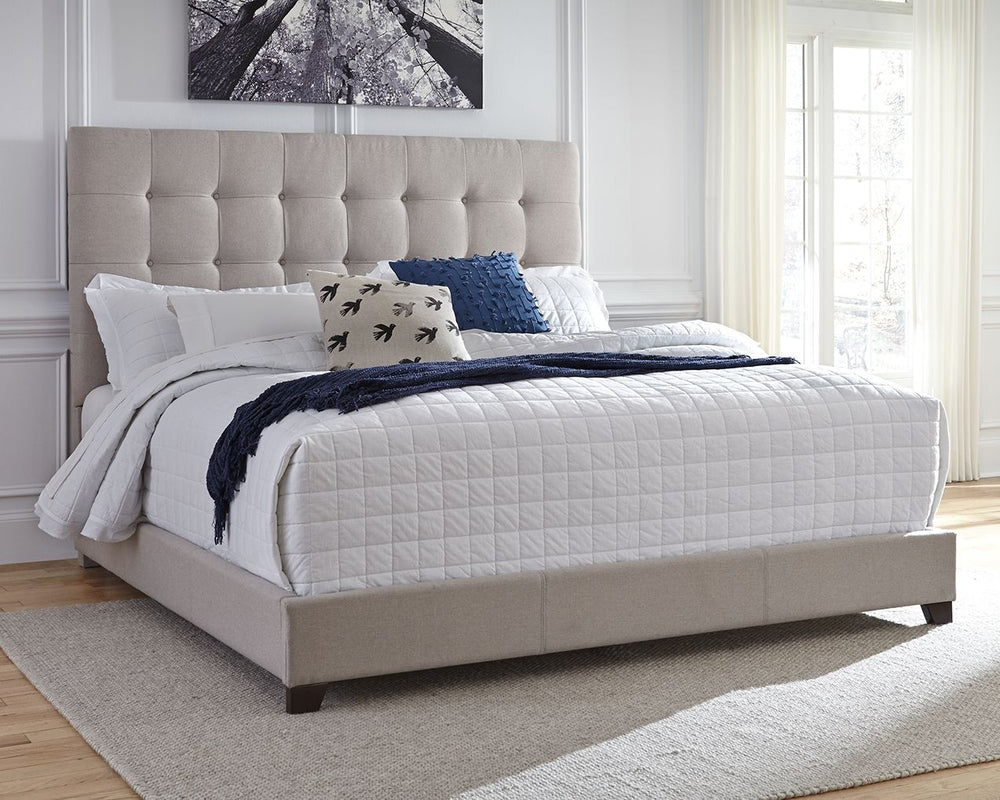 Serenity now. This queen upholstered bed is sure to awaken a love for modern platform styling with a softer side. Plush to the touch and so easy on the eyes, a pale beige fabric hugs the bedâ€”from the chic headboard with square button tufting, to the low
