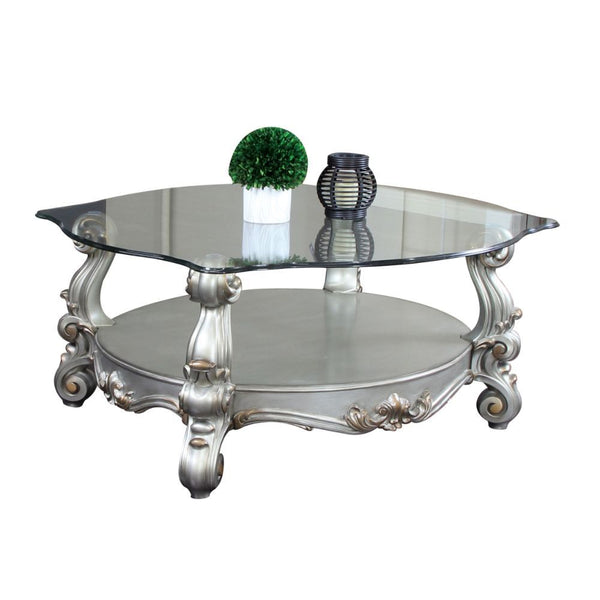 KD, Coffee Table w/Curved Glass Top â€¢ Open Compartment: Bottom Shelf â€¢ 12mm Clear Tempered Glass w/Beveled â€¢ Oversized Scrolled Legs & Shelf Apron: Poly Resin with Antique Contrast Finish<br/><br/><b>Product Features</b><ul><li>Exclusive Design</li>