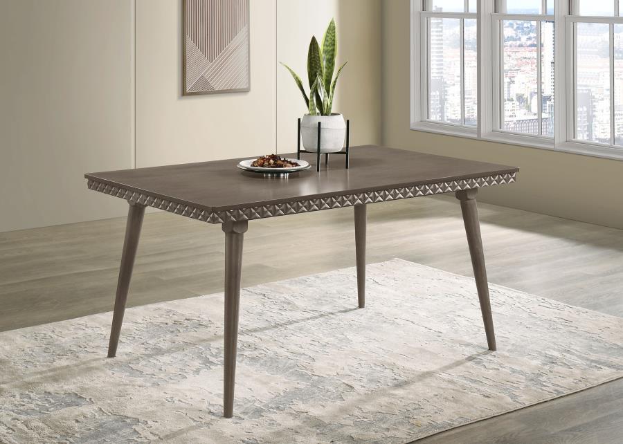 Introduce modern elegance to your dining room with this stunning 59-inch dining table. Its distinctive design features intricate detailing along the apron, adding a textural contrast to the smooth tabletop. Constructed with a blend of solid wood, engineer