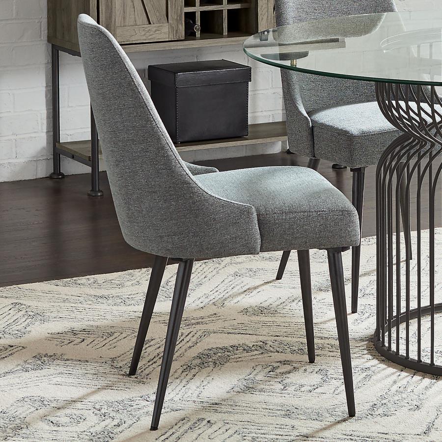 Channel mid-century charm with this armless side chair, wrapped in soft textured grey fabric. Its sleek wingback-inspired profile and gently tapered gunmetal legs bring a fresh, modern edge to dining spaces. Padded for comfort and built with durable mater