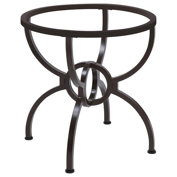 Curves abound on this intriguing transitional glass dining table. Featuring a casual and inviting aura, the table boasts a round of clear glass resting on a bold base. The base shows off metal construction with four stylized M legs that meet in an interlo
