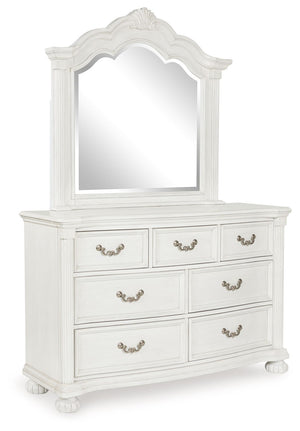 Transform your inner sanctum into a haven of timeless elegance and functionality. This traditionally styled dresser with mirror is adorned in a classic antiqued white finish, highlighted by a serpentine-shaped front with thick decorative moulding. Its dra