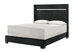 This bedroom collection strikes a balance between bold and classic styles. It features a striking bed with a high, textured headboard that commands attention. The accompanying case goods, including a dresser with a mirror, chest, and nightstand, are all f