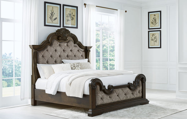  this king upholstered bed makes a bold statement. Showcasing sculptural ornate details and button tufting