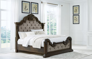  this California king upholstered bed makes a bold statement. Showcasing sculptural ornate details and button tufting