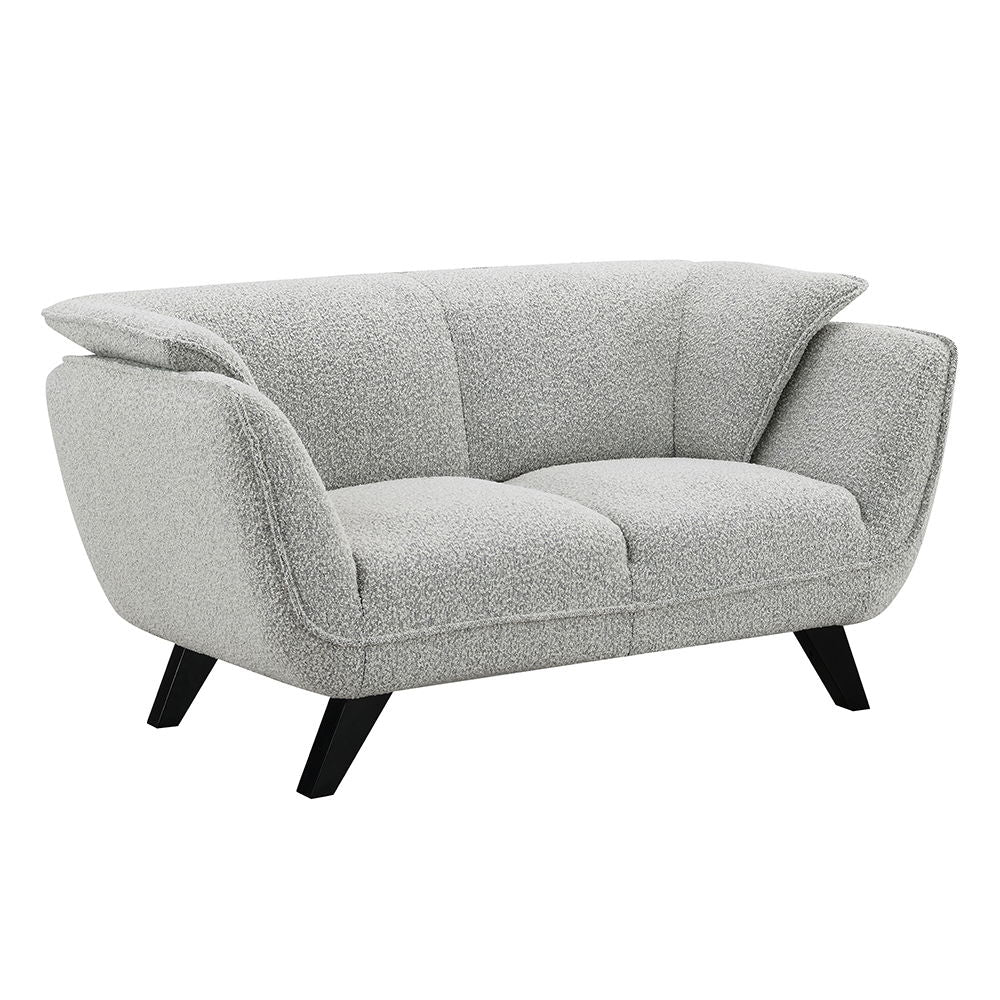 Unwind in the sophisticated charm of the Manon sofa, draped in light gray fabric. Accompanied by plush pillows, it offers a perfect blend of comfort and style. This sofa invites cozy conversations and serene relaxation, making it an ideal addition to any 