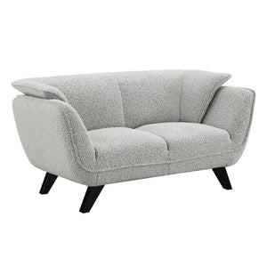  draped in light gray fabric. Accompanied by plush pillows