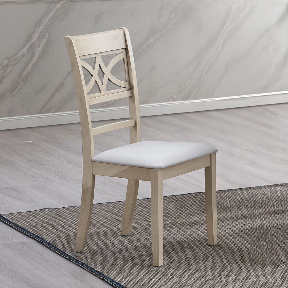Ferris dining table boasts an antique gray finish exuding timeless elegance. The set includes chairs with intricately designed backs and padded seat cushions, ensuring comfort and style for your dining experience. Perfect for both casual meals and formal 
