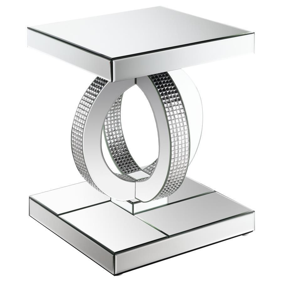 This glamorous mirrored end table brings Hollywood Regency refinement to your space. Its base features interconnected dual rings adorned with dazzling acrylic crystals, while every other surface is wrapped in sleek mirrored panels. Softly beveled edges ad