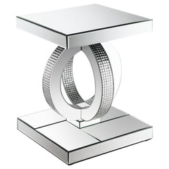 This glamorous mirrored end table brings Hollywood Regency refinement to your space. Its base features interconnected dual rings adorned with dazzling acrylic crystals, while every other surface is wrapped in sleek mirrored panels. Softly beveled edges ad