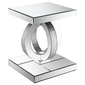 This glamorous mirrored end table brings Hollywood Regency refinement to your space. Its base features interconnected dual rings adorned with dazzling acrylic crystals, while every other surface is wrapped in sleek mirrored panels. Softly beveled edges ad