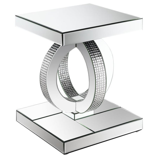 This glamorous mirrored end table brings Hollywood Regency refinement to your space. Its base features interconnected dual rings adorned with dazzling acrylic crystals, while every other surface is wrapped in sleek mirrored panels. Softly beveled edges ad