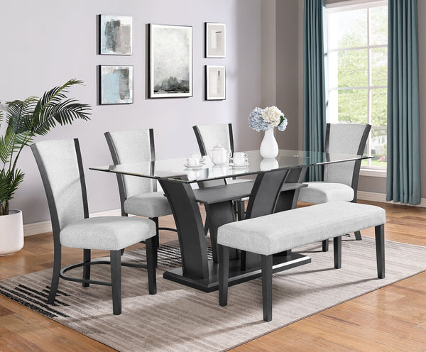 This sleek and modern dining group bridges form and function. The sculptural dining table has a sturdy base and the glass top allows views of the upholstered open shelf. Streamlined chairs and bench feature pewter finished wood and dove gray upholstery fo