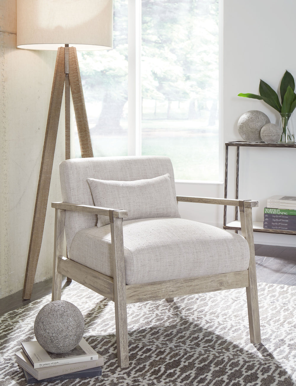 Keep your seating casually cool with this accent chair. The clean-lined design sports a gray finish for a modern appeal, while light neutral upholstery in a herringbone pattern creates textural interest. Antiqued pewter-tone accents add a touch of urban f